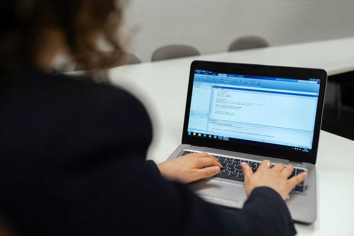 Engineer preparing pre-compliance certification test documentation on a laptop